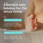 A promotional graphic for a gentle baby cleanser, featuring a close-up of a baby's foot resting in a bathtub. The image includes text overlays highlighting 'A Gentle & Safe Solution For The Whole Family' along with 'PEDIATRICIAN APPROVED' and 'DERMATOLOGIST APPROVED' badges.