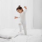 close up of a little girl wearing Rejuvaskin's tencel cotton baby sleepsuit for eczema relief 